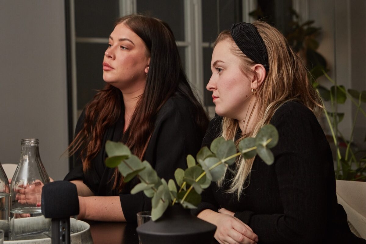 2 kvinnor sitter och lyssnar